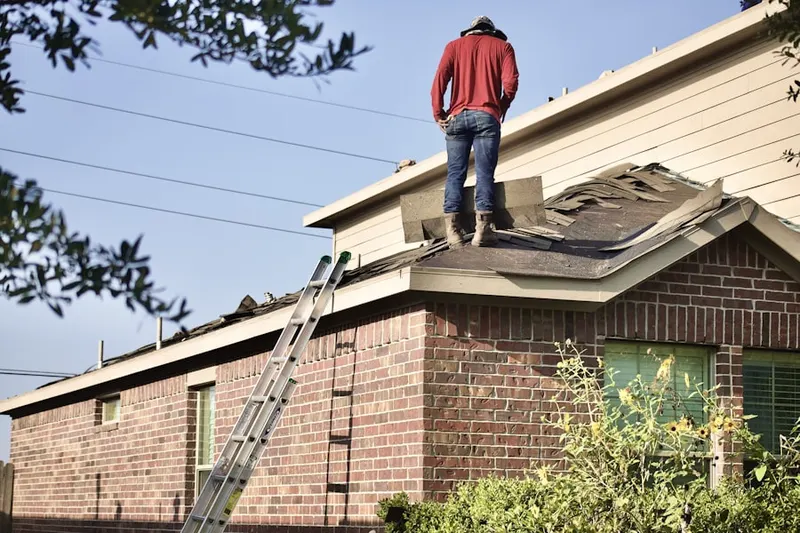 Professional roofer working on a residential roof in South Portland